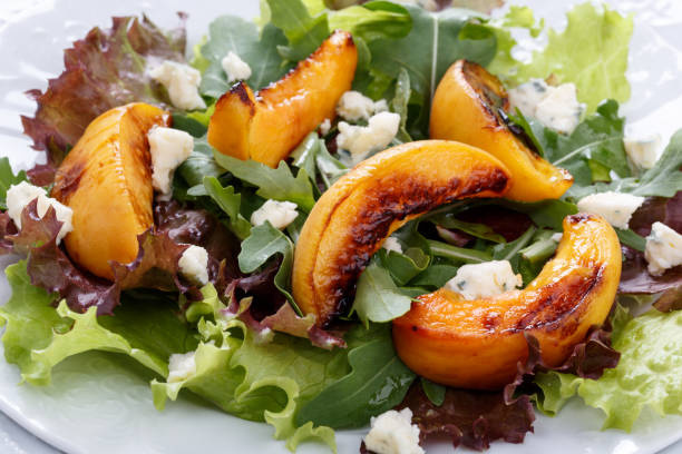 Grilled peach salad with arugula and goat cheese